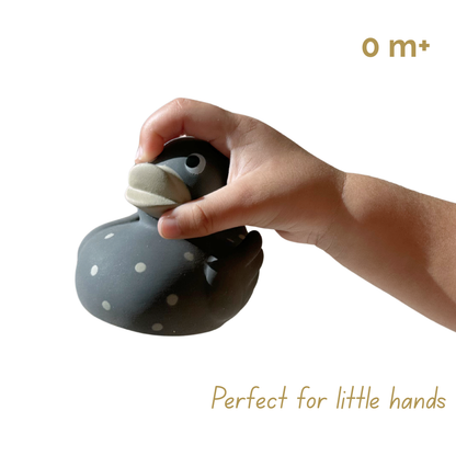 Baby hand holding a natural rubber duck 'Perfect for little hands', '0 m+' Toy, Bath Duck, Gift. Mama and Bubba